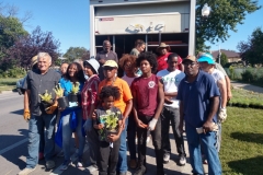 Volunteers unloaded trucks and set up plant groupings on August 24 under blue skies.